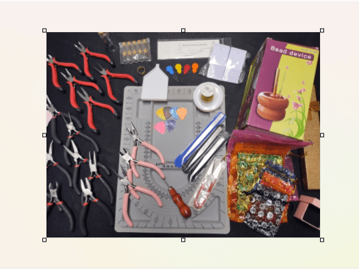 Assorted jewelry-making kit featuring various pliers, a bead design board, and colorful organza bags.
